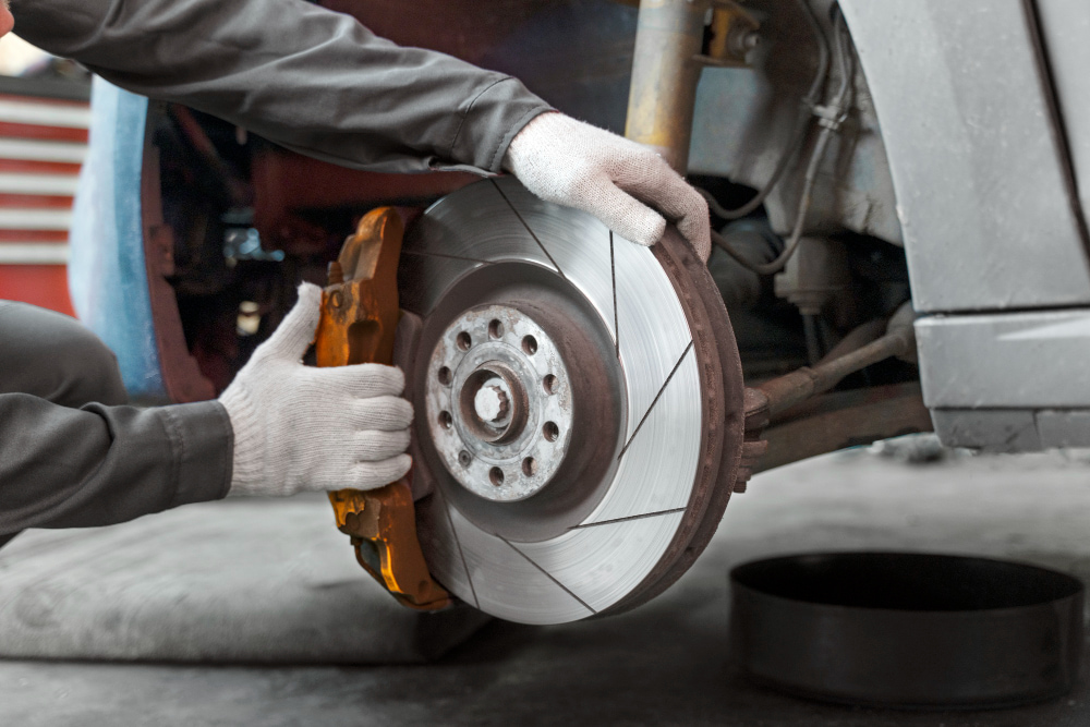 Mechanic inspecting worn brake pads in Northern Beaches workshop