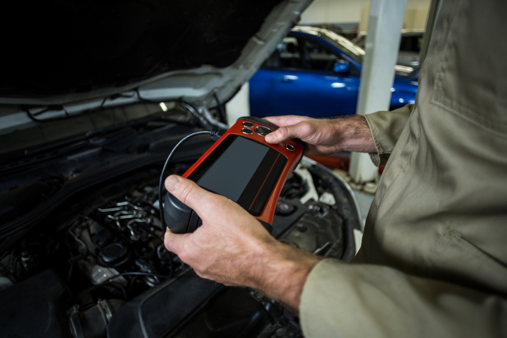 Mechanic using diagnostic scan tool to read engine fault codes